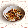 Try Sichuan Red Oil Dumplings at Wok Manifesto, Newcastle. Juicy handmade pork dumplings tossed in house-made crispy chilli oil and soy sauce, topped with peanuts, garlic and Sichuan spices – bold, fragrant and unmistakably Sichuan.