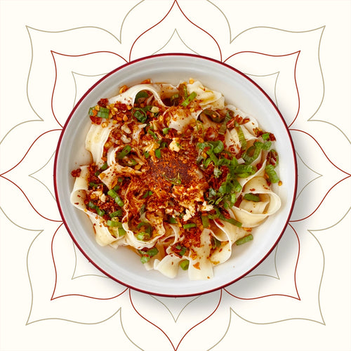 Red Oil Noodles topped with garlic, chilli flakes, and spring onions, freshly made at Wok Manifesto – authentic Shaanxi street food in Newcastle.