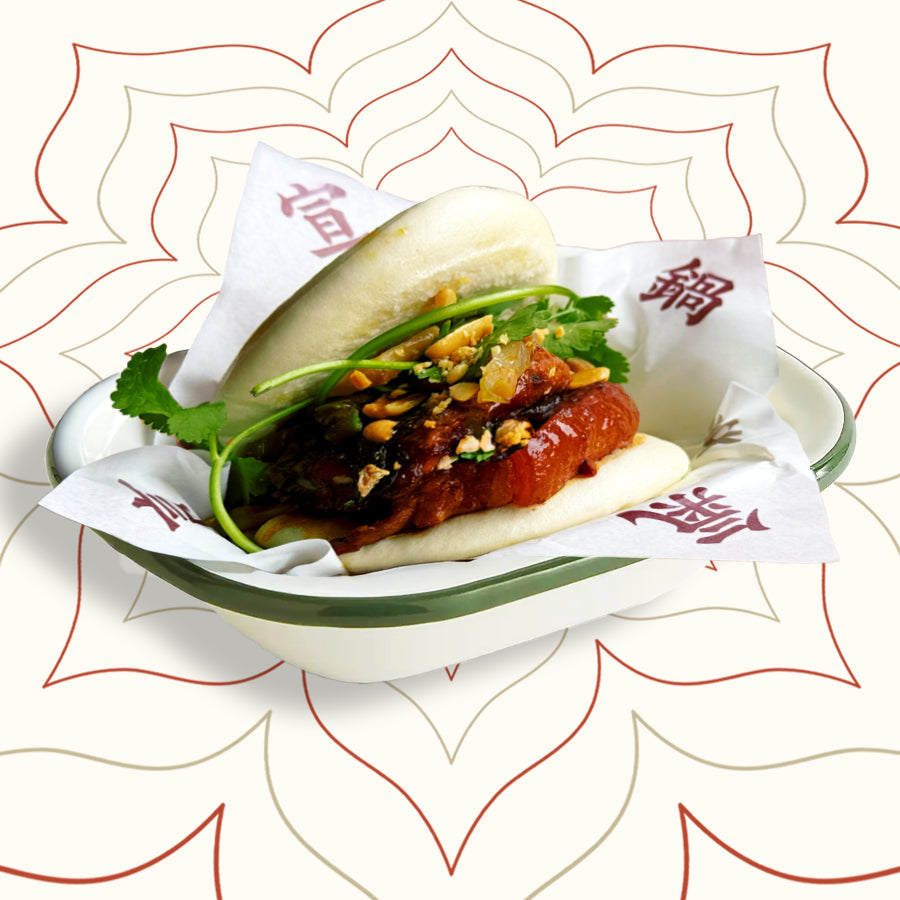 Soft bao buns filled with braised pork belly, pickled greens and crushed peanuts – a comforting Taiwanese street food favourite served at Wok Manifesto Newcastle.