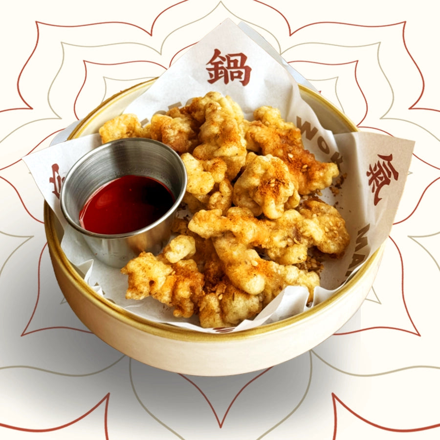 Sichuan crispy pork with golden crust and juicy centre, marinated in peppercorns and served with fruity dipping sauce – bold street food from Wok Manifesto Newcastle.